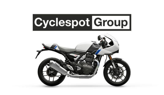2026 Triumph Thruxton 400 in Pearl Metallic White/Storm Grey cafe racer motorcycle with Cyclespot Group logo above it on a white background